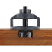 Woodworking router bit inserted into a wooden board on a white background